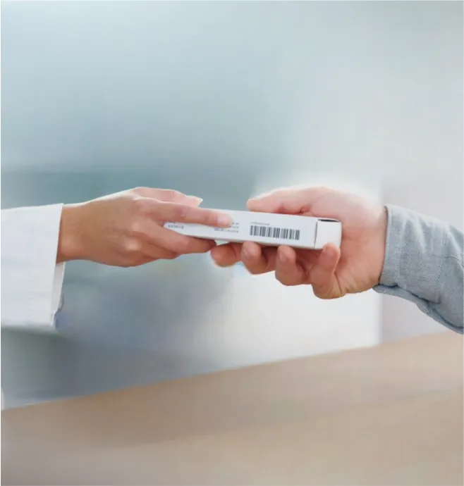 Pharmacist handing over prescription